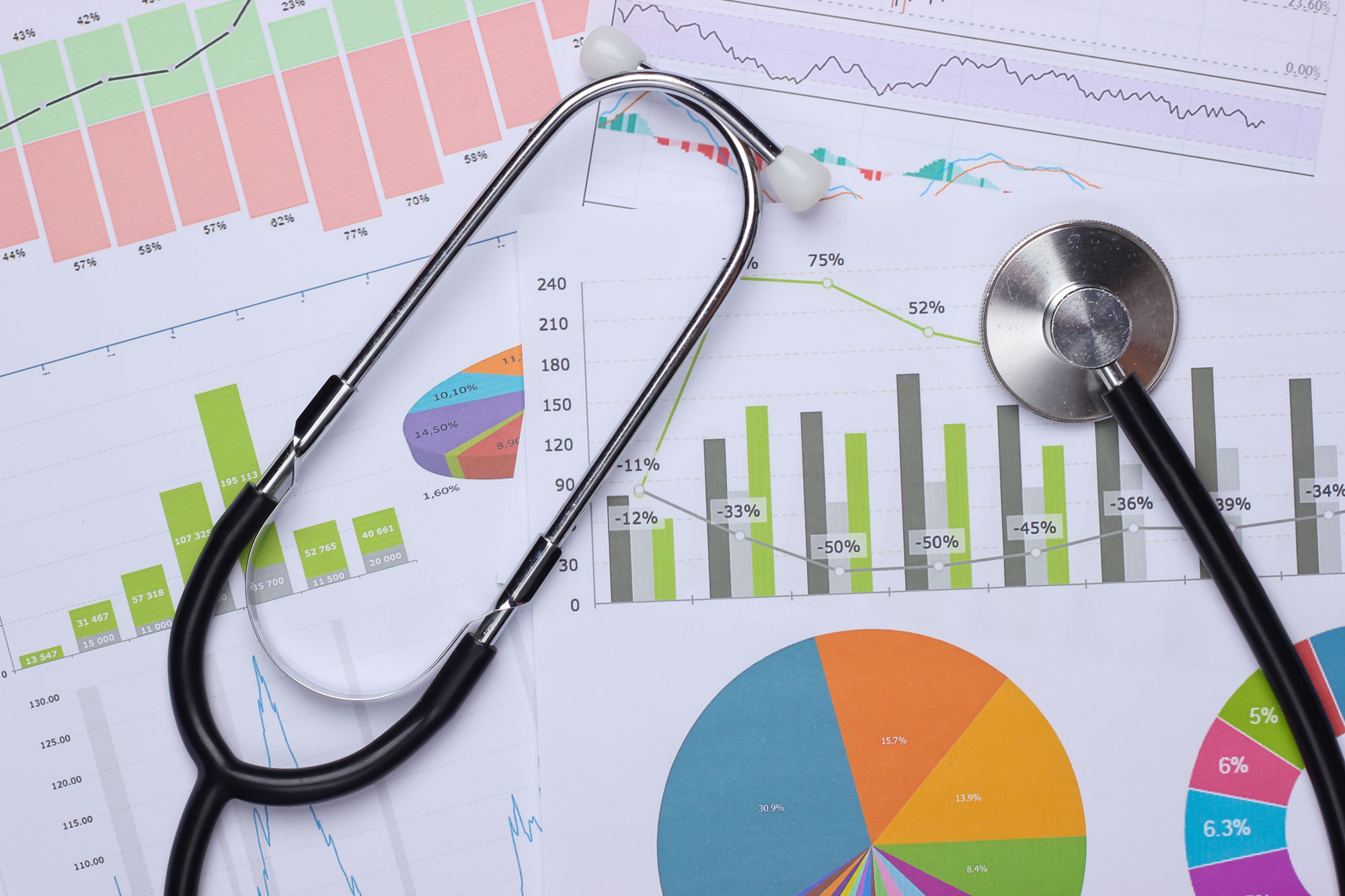 stethoscope on top of graphs of medical data
