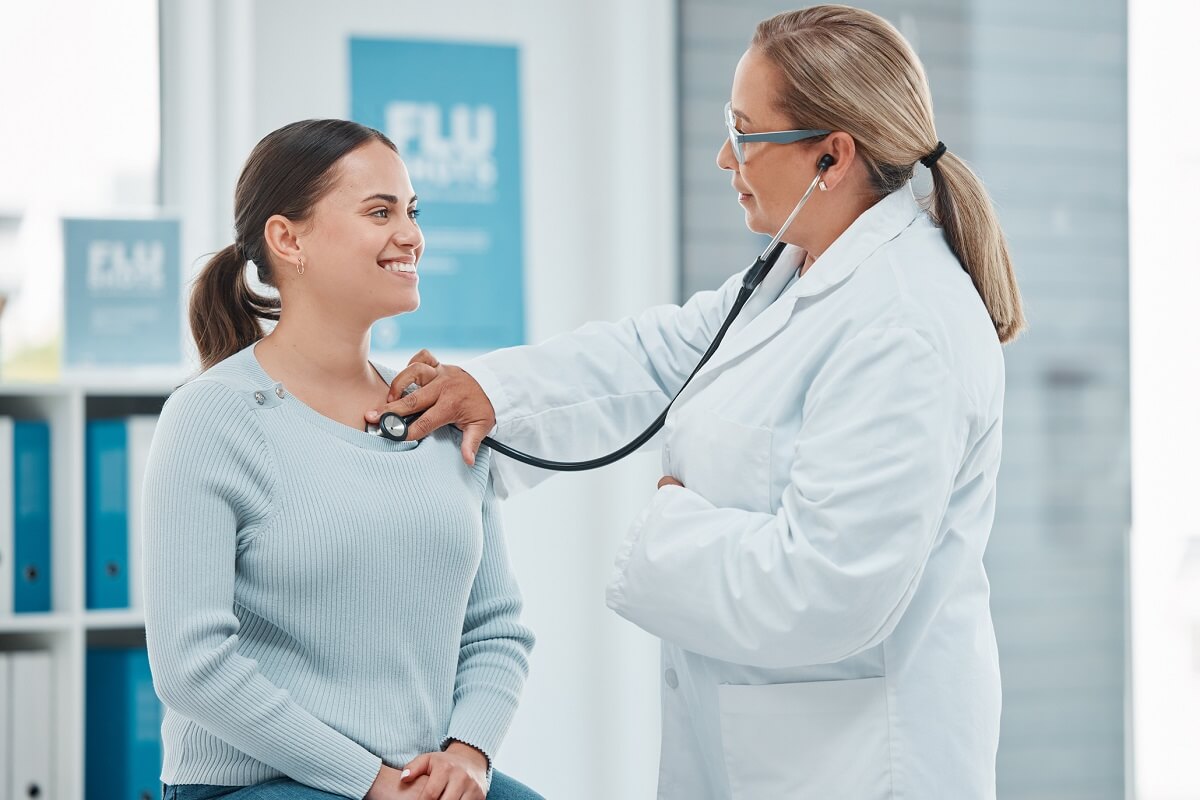 Nurse Practitioner examining a female patient with a stethoscope